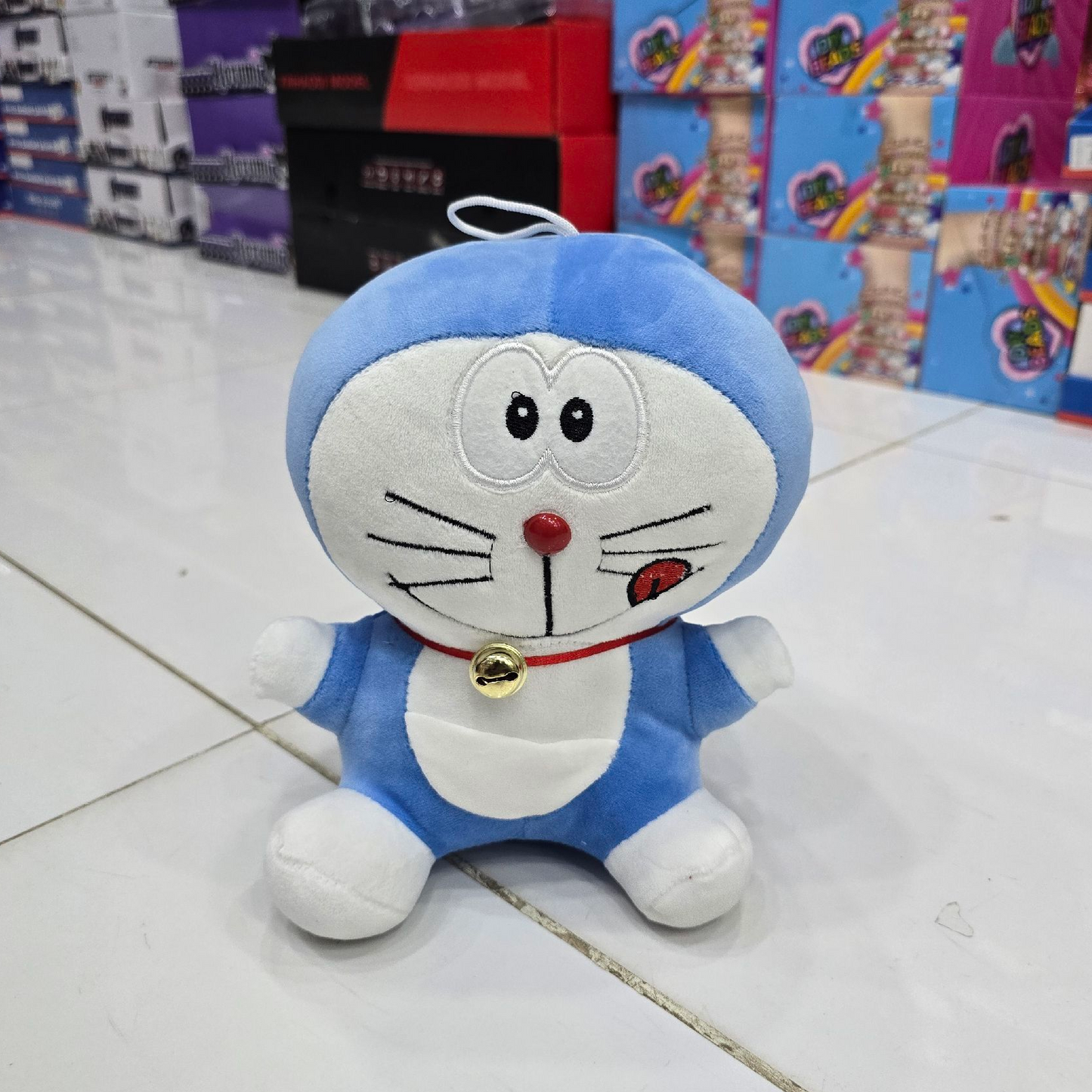 Plush toy resembling a cartoon character on a tiled floor with store shelves in the background